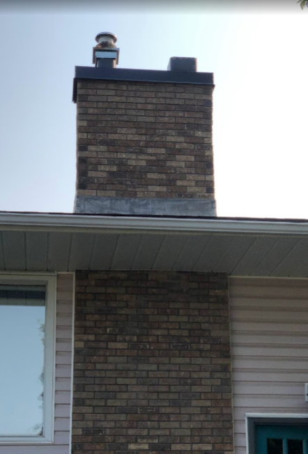 chimney with a dark blue crown and multi colour bricks