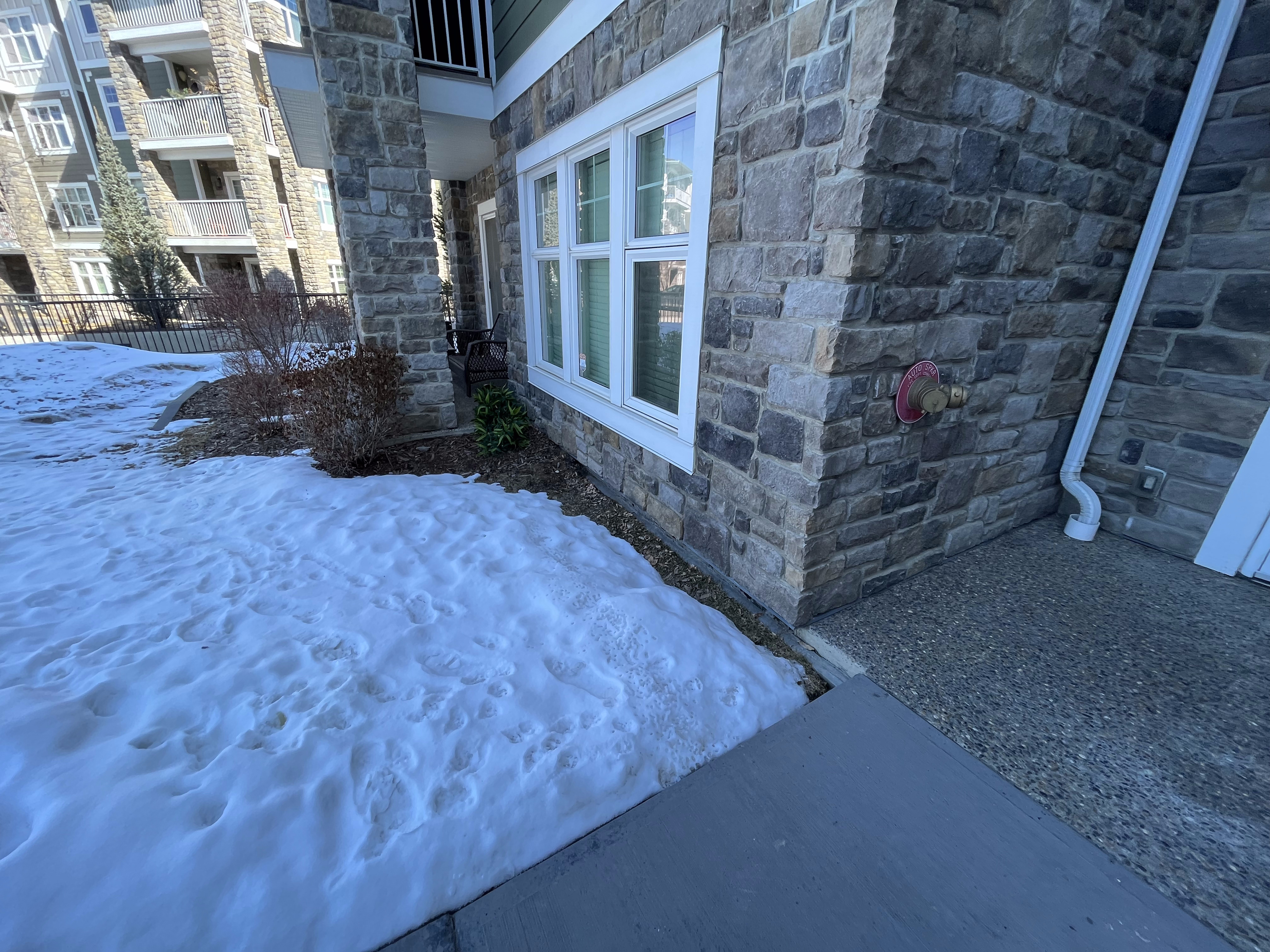 Stone veneer exterior wrapped around apartment windows